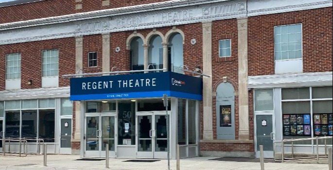 Exterior of modern brick with glass doors and Overhead Regent signs