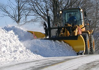 Snow plow on a street with snow