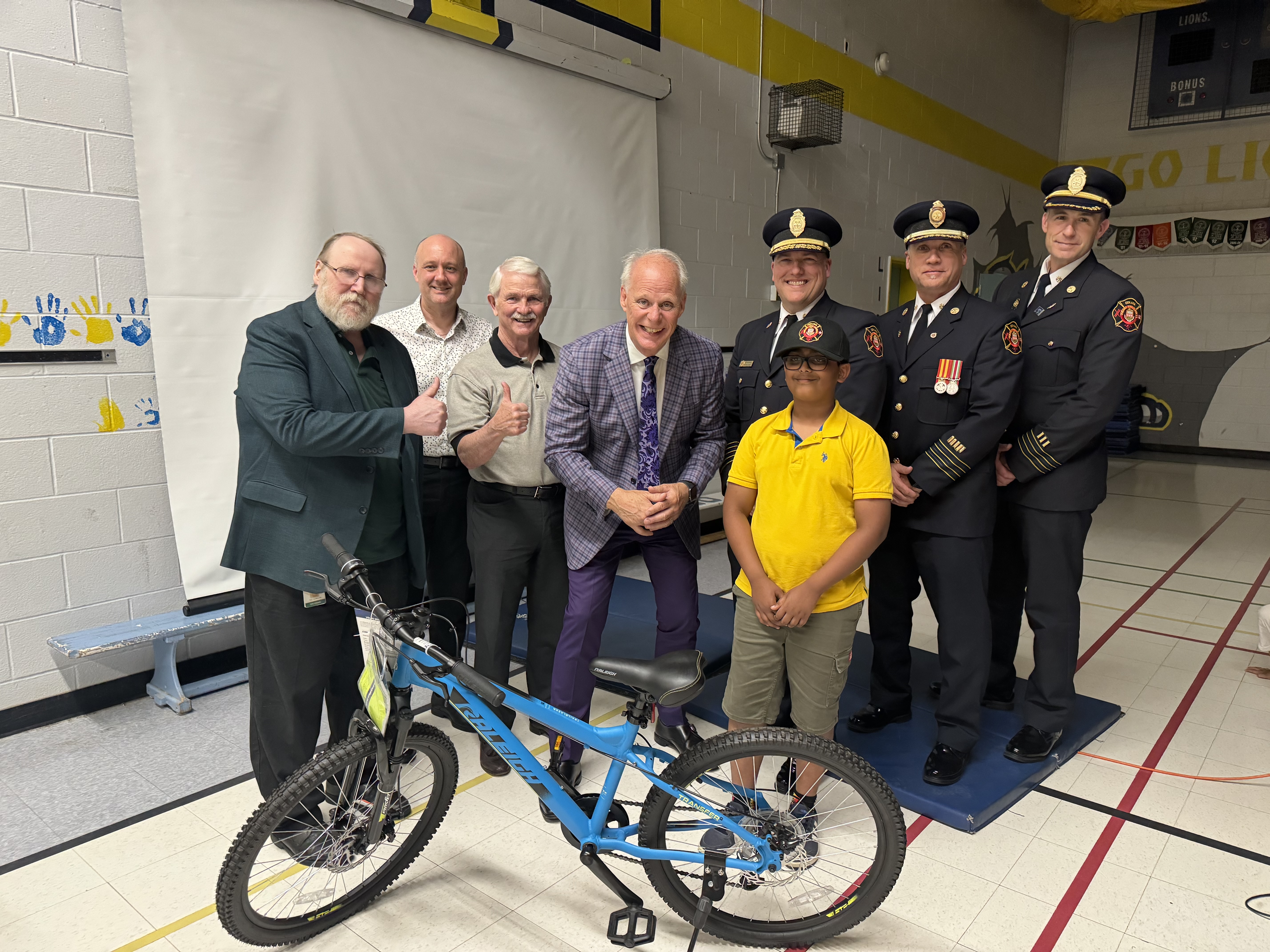 Mayor and Council, Oshawa Fire Services, Commissioner all pose with 2024 Junior Fire Chief