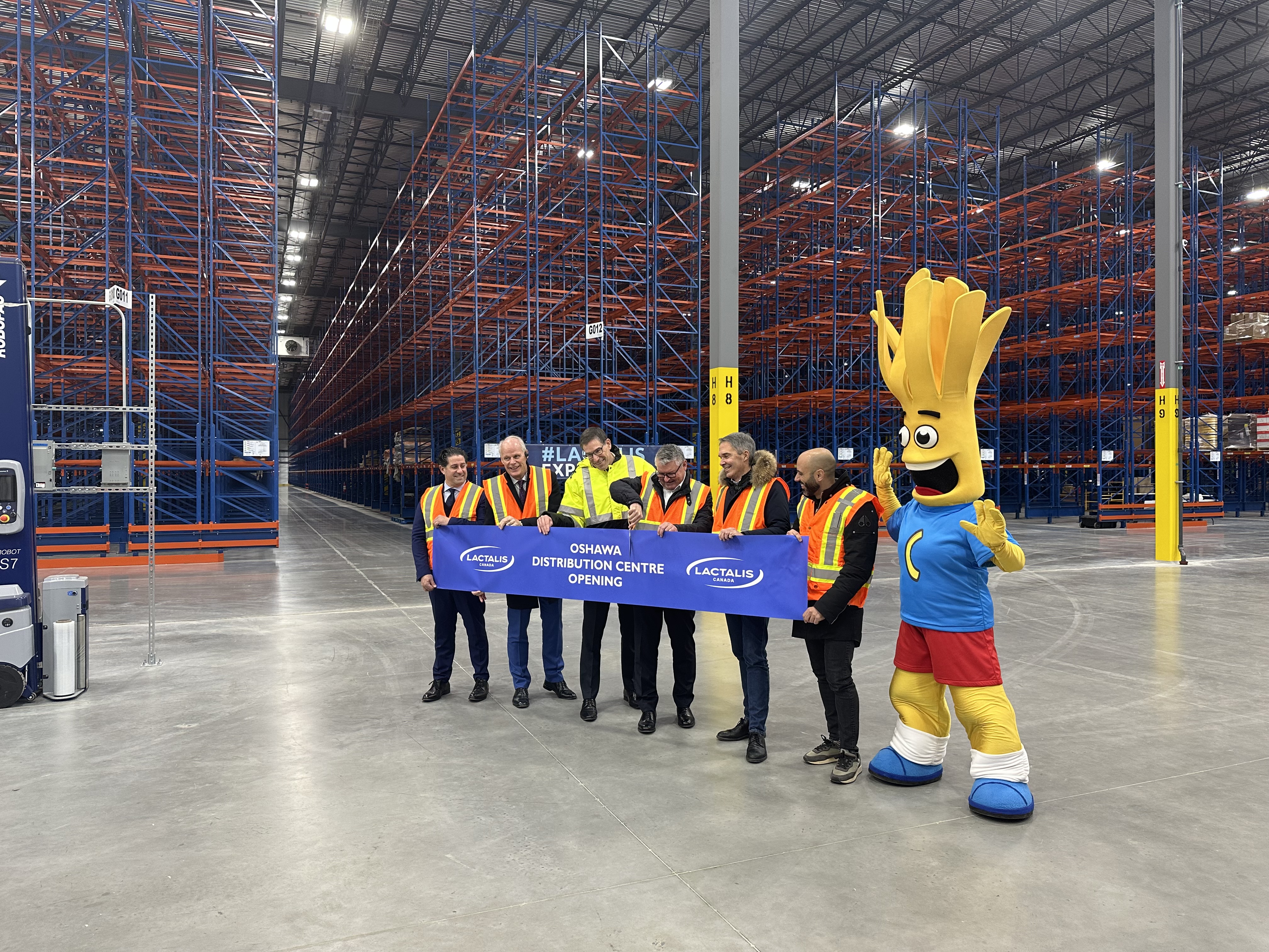 members of Oshawa City Council and representatives of Lactalis Canada cut the ribbon on the new global distribution facility in Oshawa's Northwood Business Park