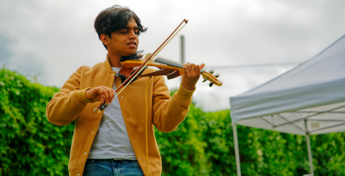 Close up of violin player performing outdoors