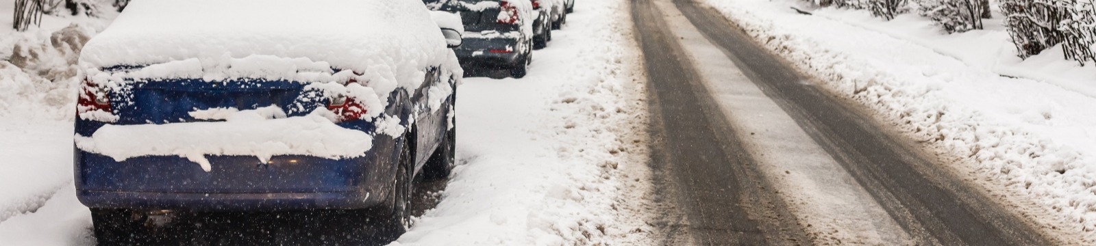 Car parked on road in snow