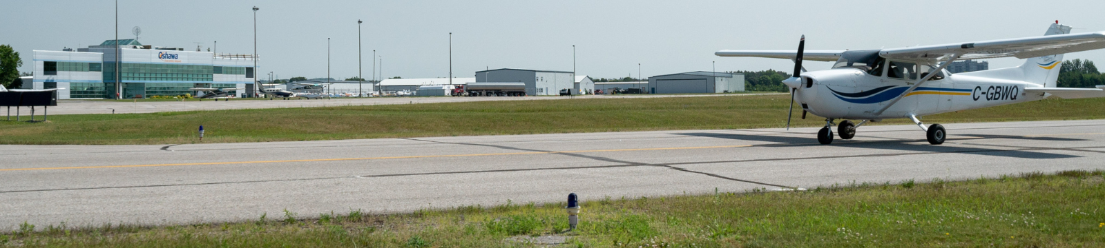 Airplane taking off on runway at Oshawa Executive Airport