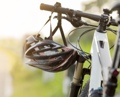Mountain bike with bike helmet hanging from handlebars Mountain bike with bike helmet hanging from handlebars